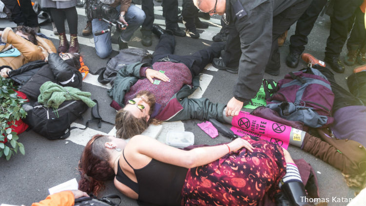 Protestors lie on the bridge to stop movement of traffic.