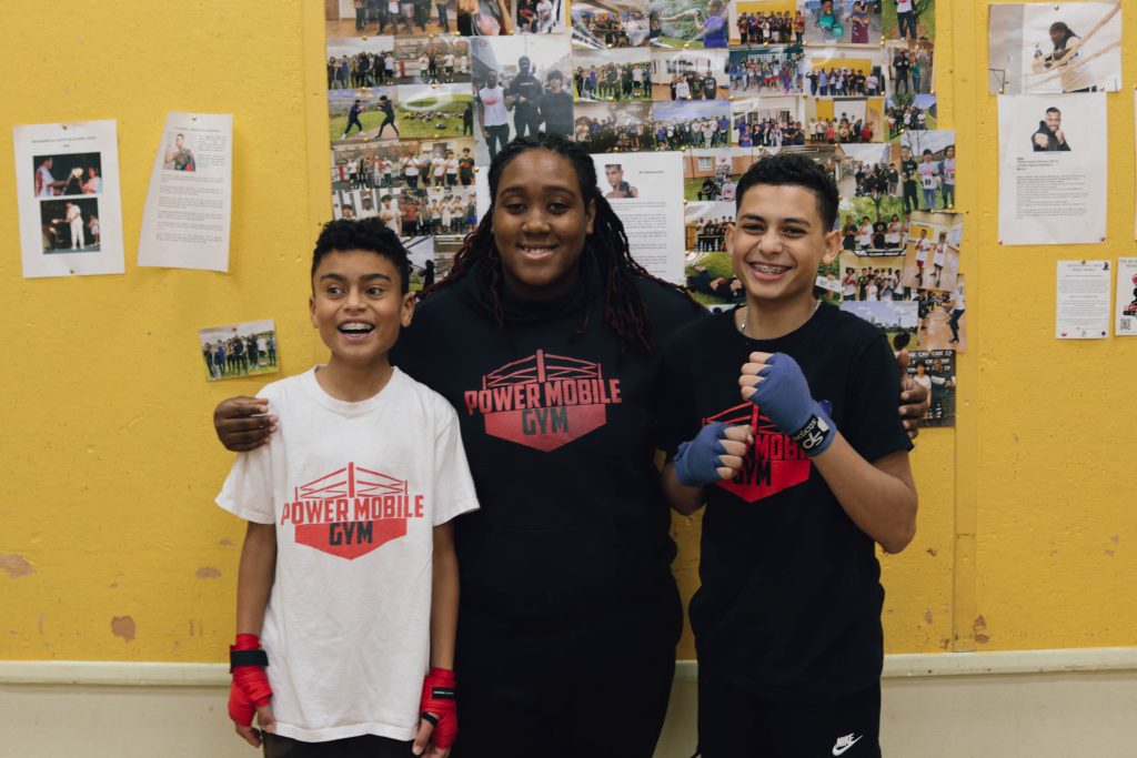 Coach Shan with two student boxers. Photograph: Molly Smith