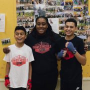 Coach Shan with two student boxers. Photograph: Molly Smith
